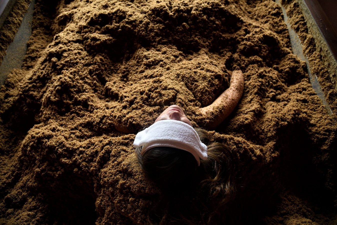 Woman in cedar enzyme bath at Osmosis Day Spa Sanctuary